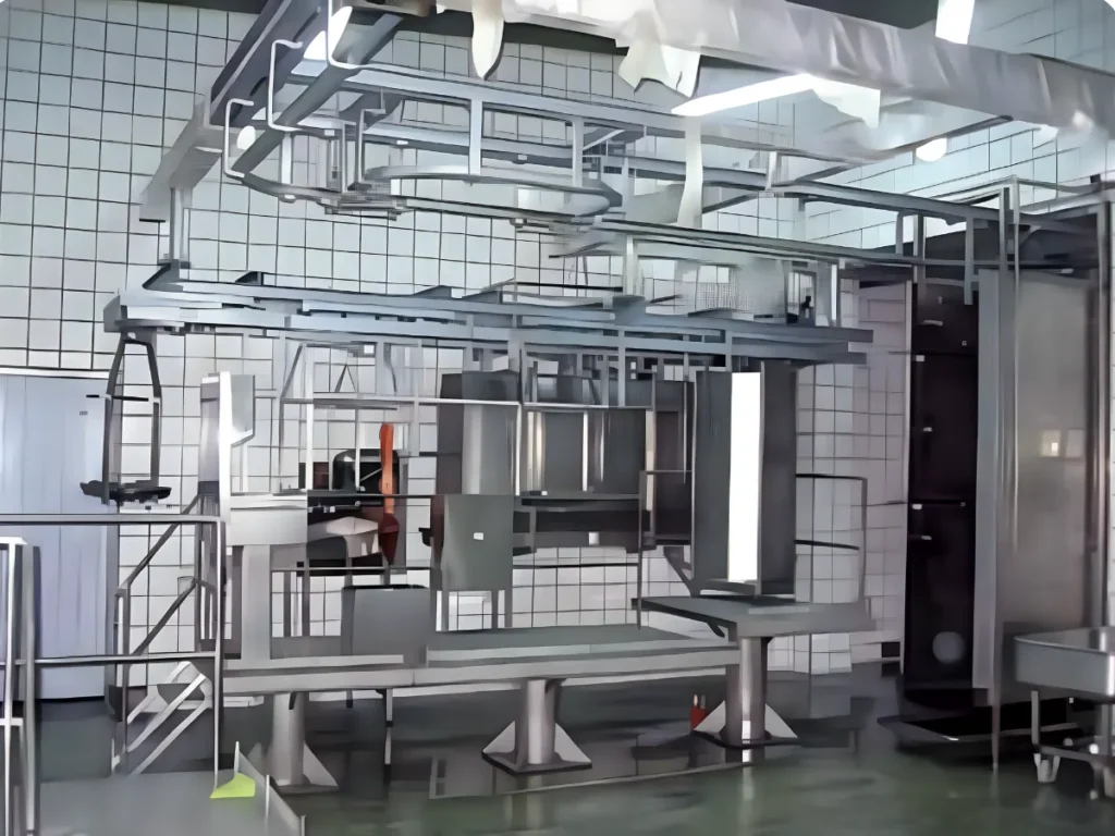 Stainless-steel working platforms, overhead conveyor and structural elements in the clean zone of a meat-processing facility.
